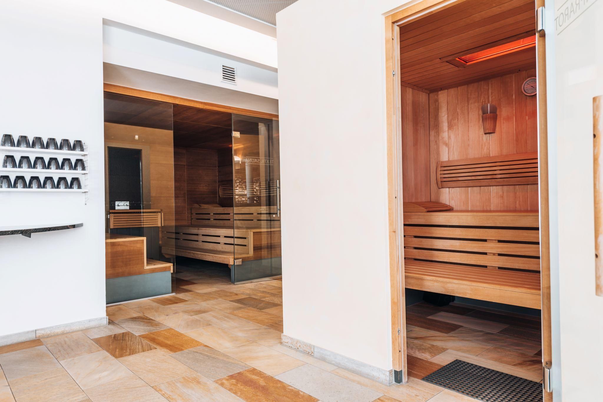 A modern spa with wooden saunas and stylish interior. The space has flowing lines and a relaxing atmosphere.
