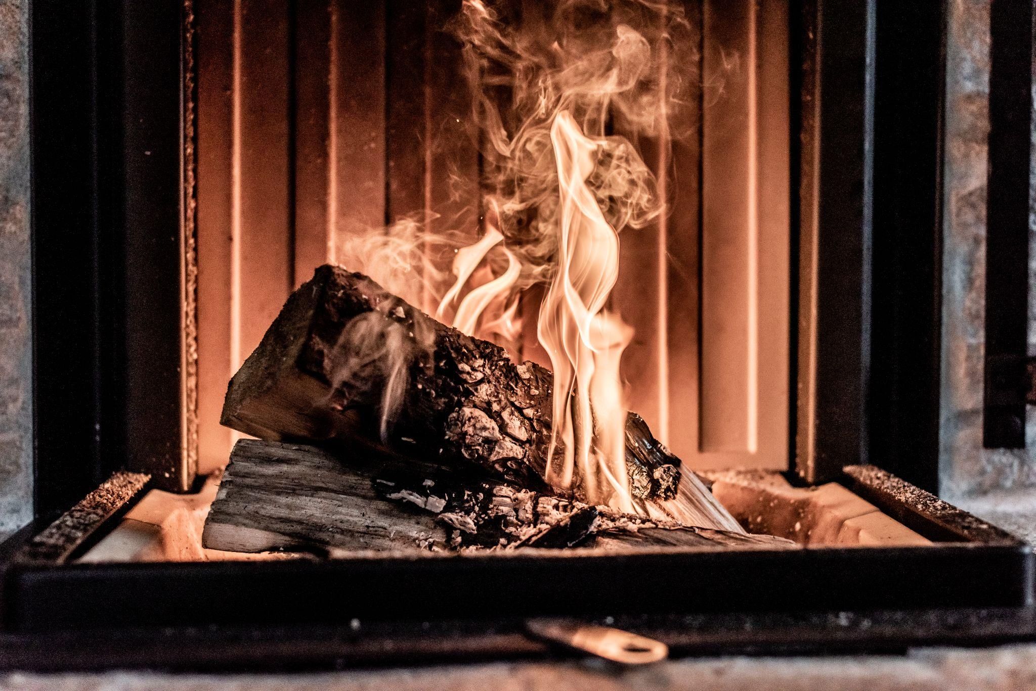 A crackling fire in the fireplace with blazing flames. The atmosphere is warm and cozy.