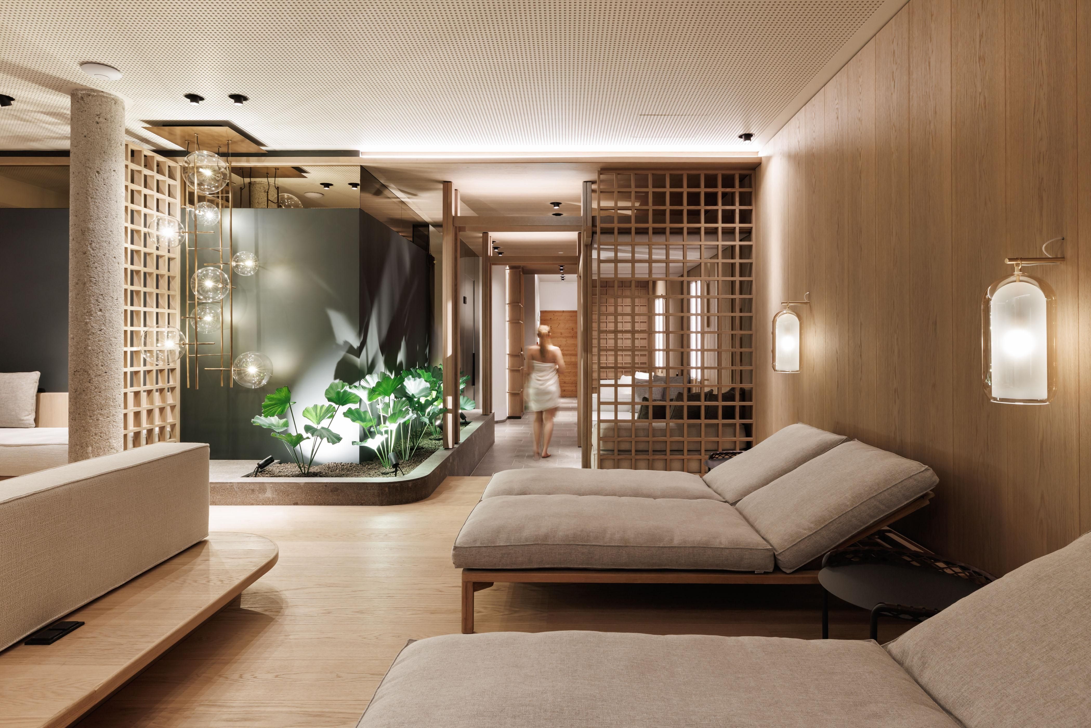 An elegant wellness area with modern loungers and warm wooden tones.
Plants and soft lighting create a relaxing atmosphere.
