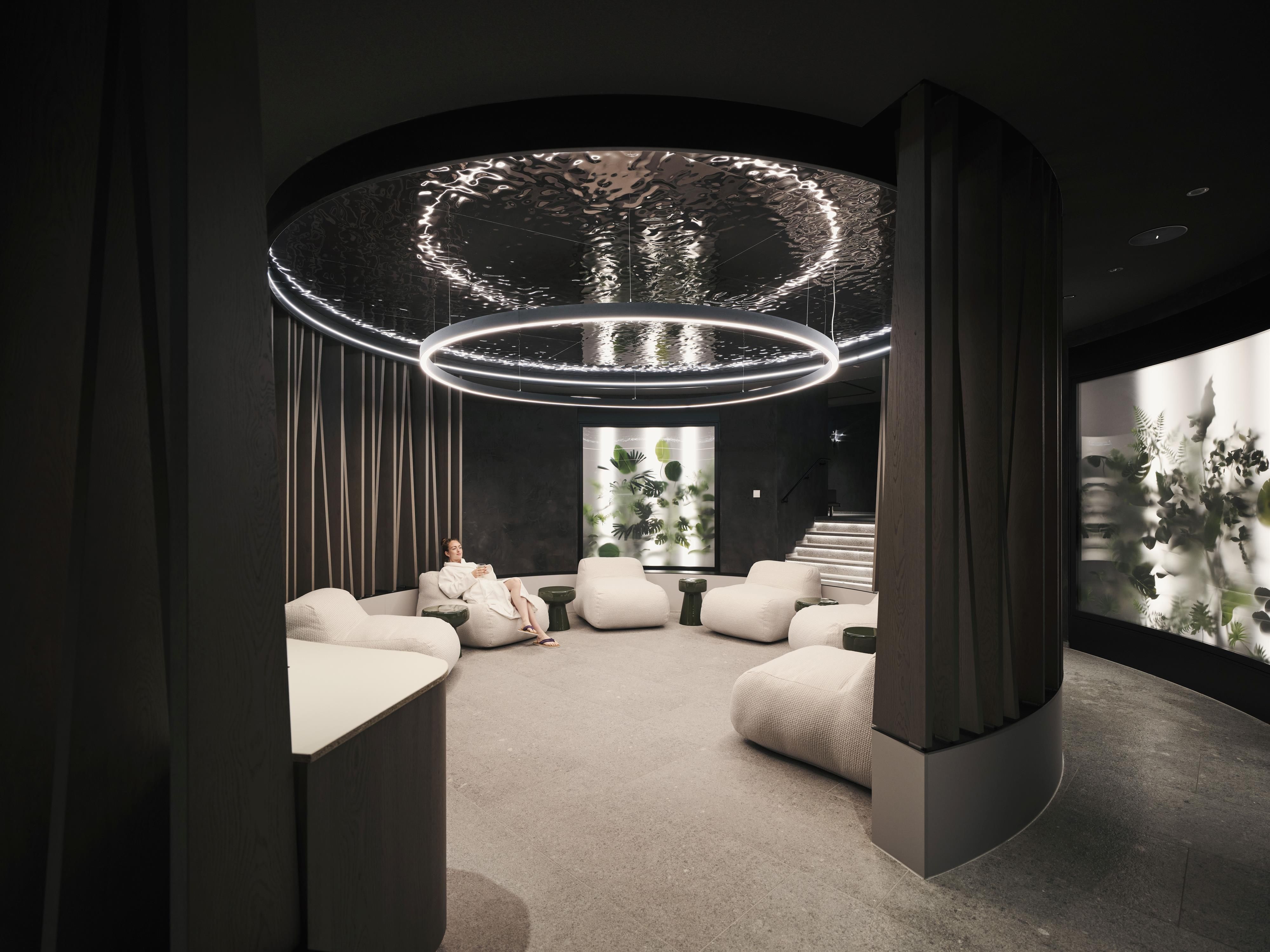 A modern interior with cozy bean bags and soft lighting. The walls are designed with calm colors, creating a relaxing atmosphere.